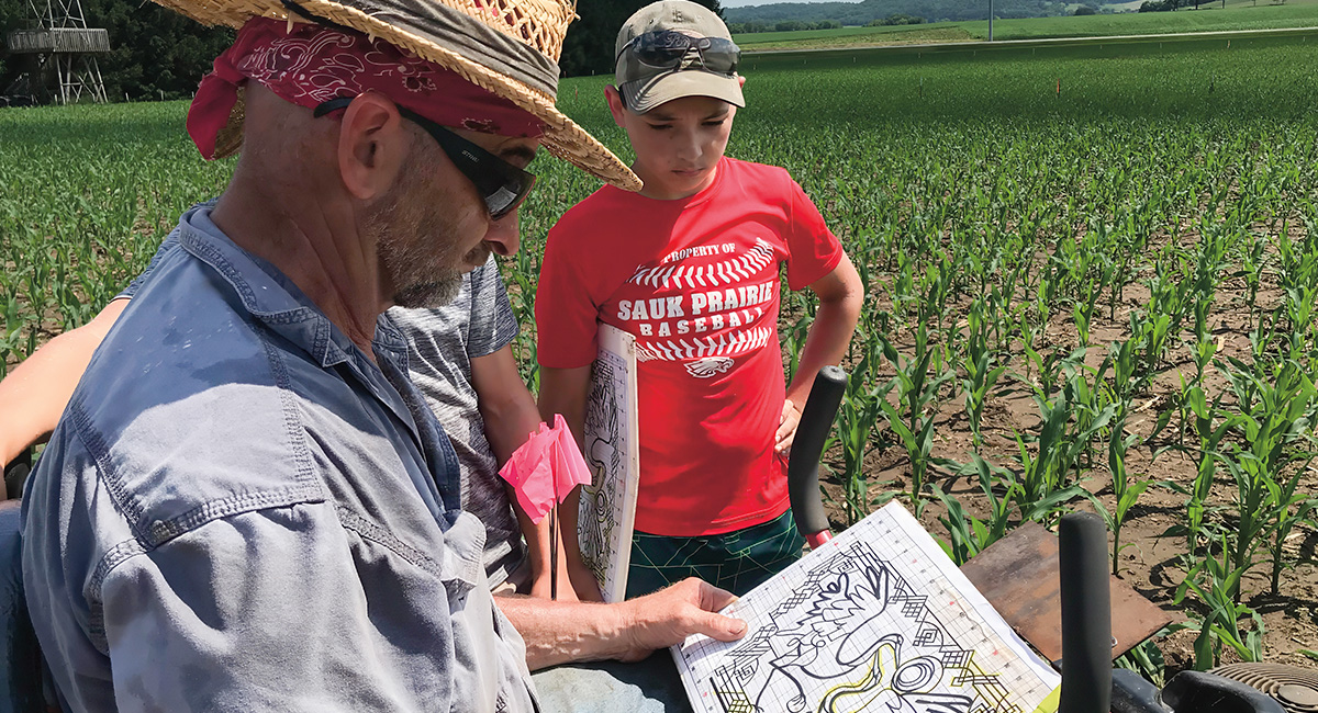 Image of people analyzing a map for a corn maze